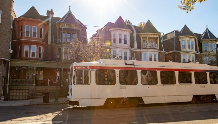 A SEPTA trolley driving through a neighborhood