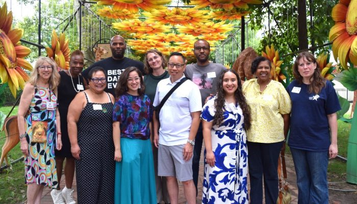 A group of 11 Philadelphians pose for a photo in the Chinese Lantern Festival at Franklin Square.