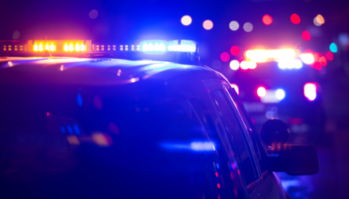 Police cars with their sirens on.