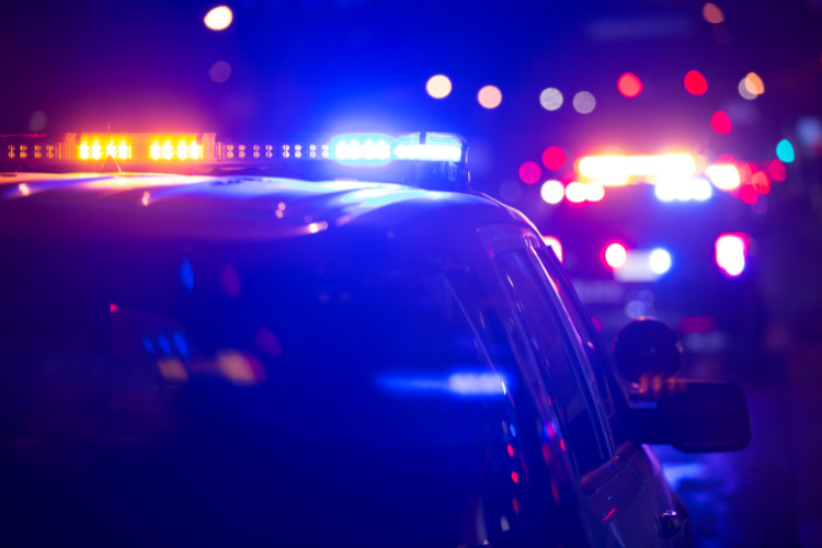 Police cars with their sirens on.