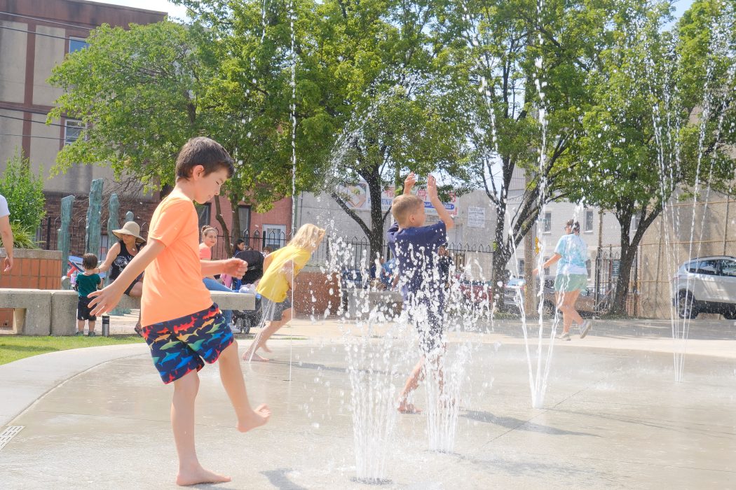 Children playing at a water feature park