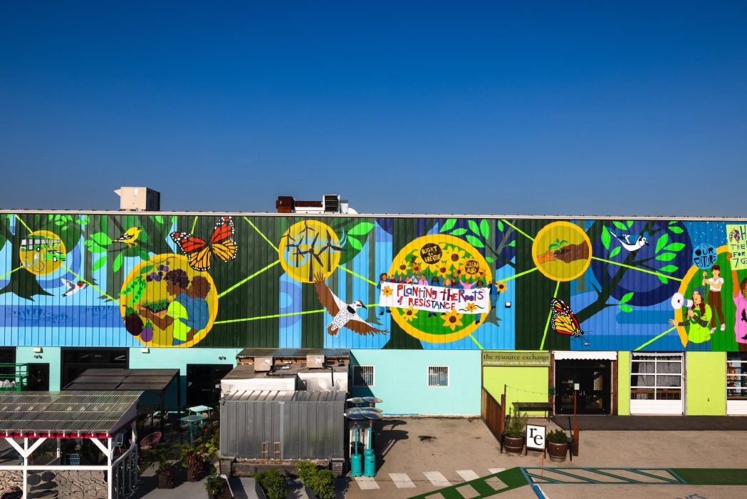 A photo of a large and colorful mural painted across the front of a building.