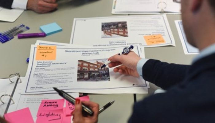 Picture of employees looking over documents in a meeting room
