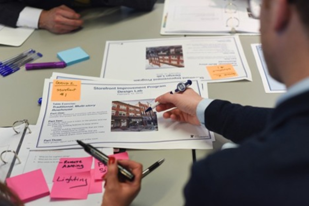 Picture of employees looking over documents in a meeting room