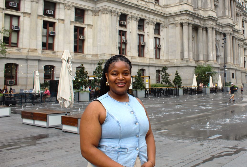 Kai Moore, MIP Intern standing in front of City Hall at Dilworth Park