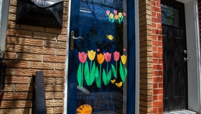 Front door of a house, with flowers painted on it.