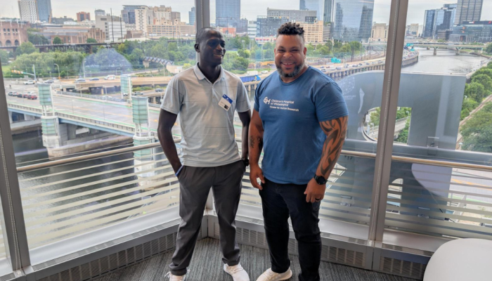 Macfarlen and rep from CHOP posing in picture.