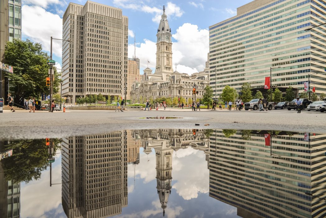 Image of City Hall with a reflection of the building in pool of water
