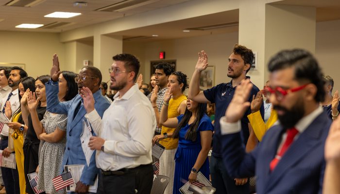Group of people participating in naturalization ceremony