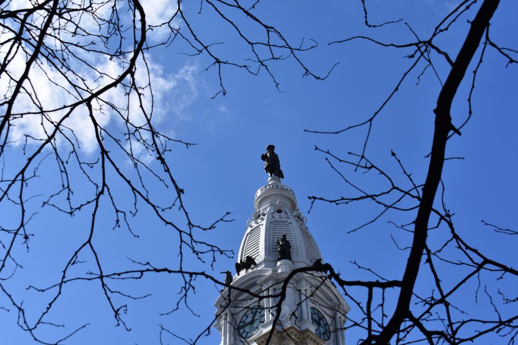 City Hall tower in Philadelphia behind tree branches