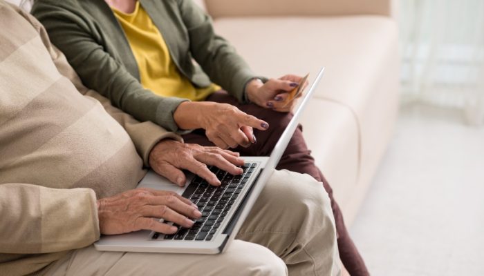 Older couple browsing on laptop