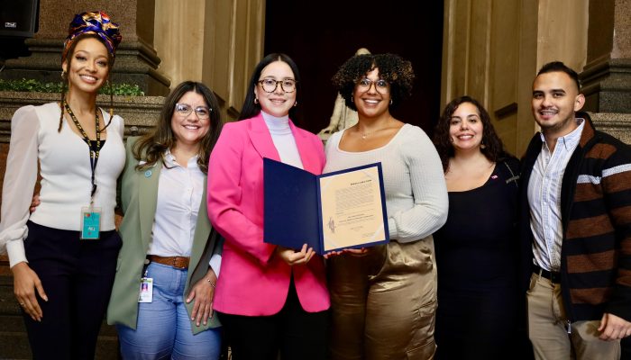 Vanessa Caracoza accepts resolution for Hispanic Heritage Month.