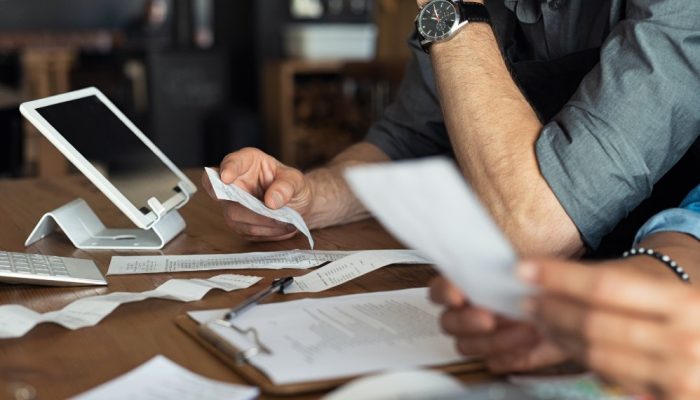 Individuals reviewing receipts