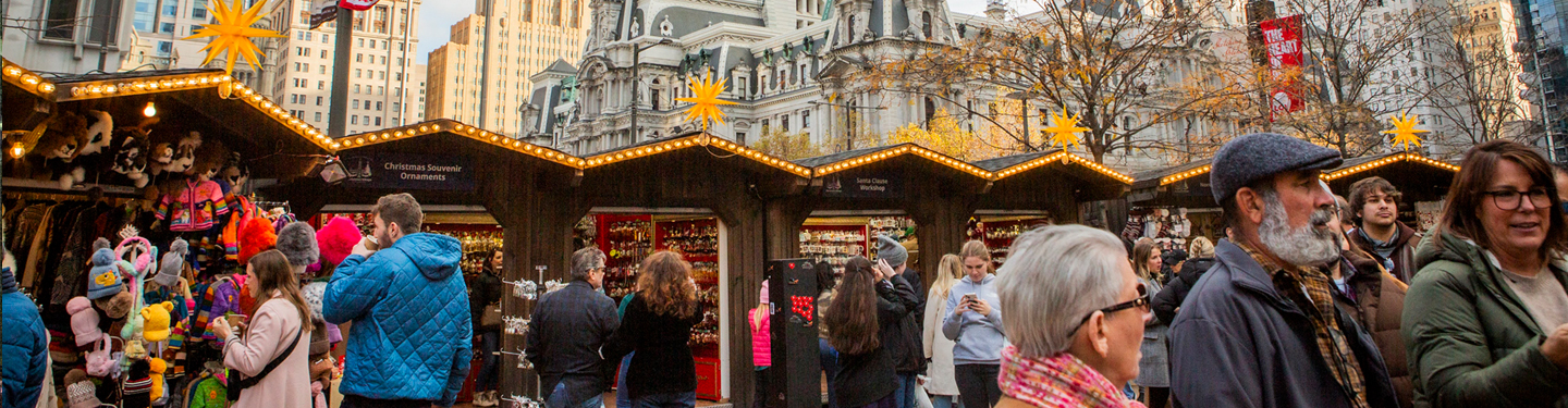 People walking through Christmas Village market
