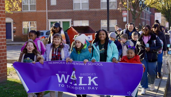 Elementary school students carrying banner during their march honoring Ruby Bridges