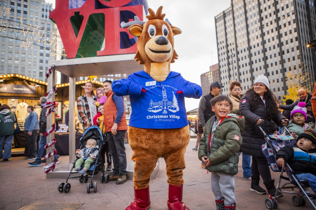 Mascot Phil The Reindeer in front of the LOVE park sculpture.