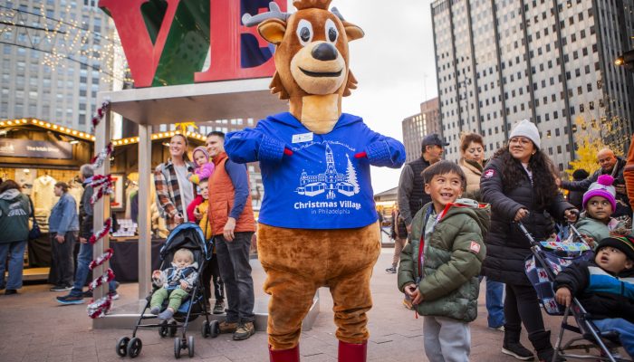 Mascot Phil The Reindeer in front of the LOVE park sculpture.