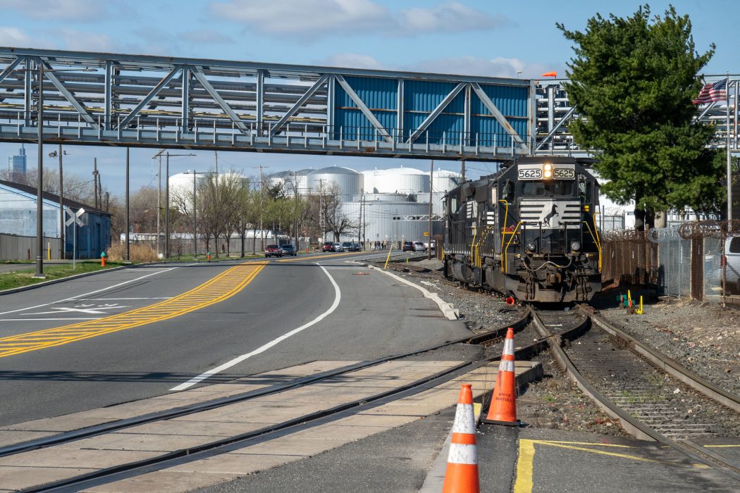 A photo of the Port Richmond Industrial District, featuring Delaware Avenue with a freight train stopped in the siding along the avenue.