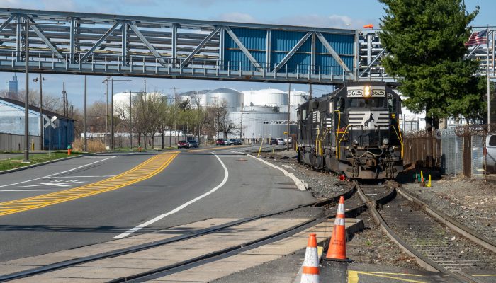 A photo of the Port Richmond Industrial District, featuring Delaware Avenue with a freight train stopped in the siding along the avenue.