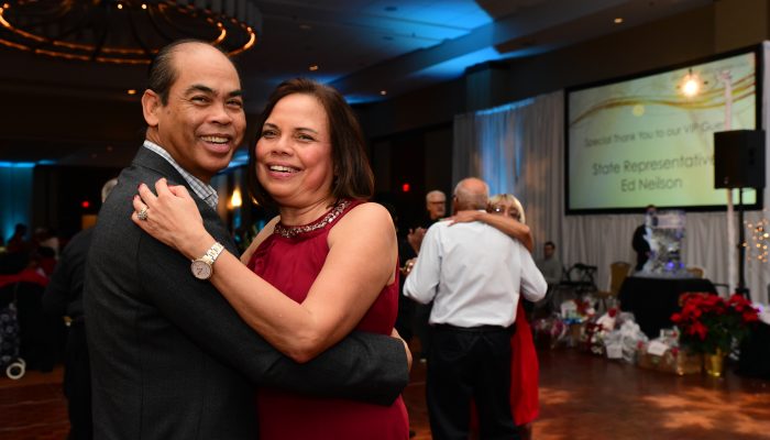 A couple embrace on the dance floor.