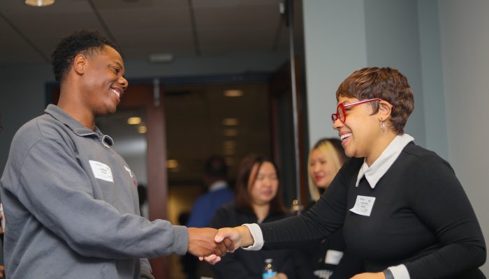 Business services manager shaking hands with a member of the community.