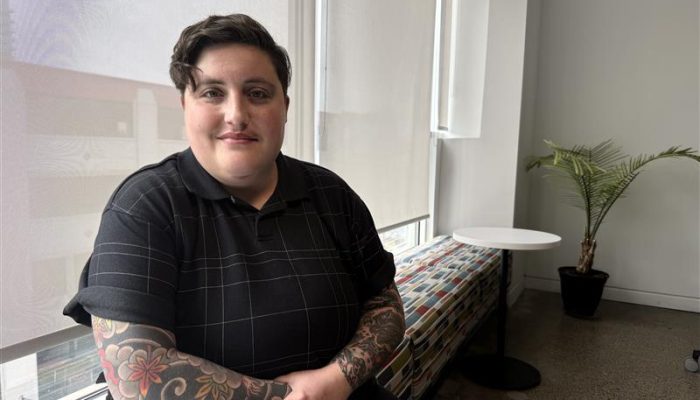 Olivia posing in a meeting room.