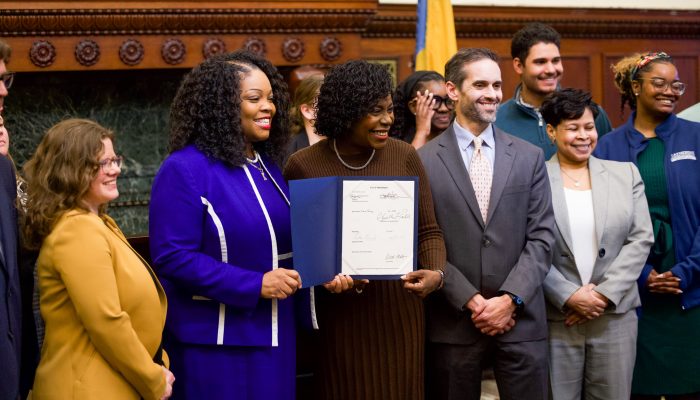 Mayor Cherelle L. Parker, Council Majority Leader Katherine Gilmore Richardson, and City officials holding up a newly signed bill.