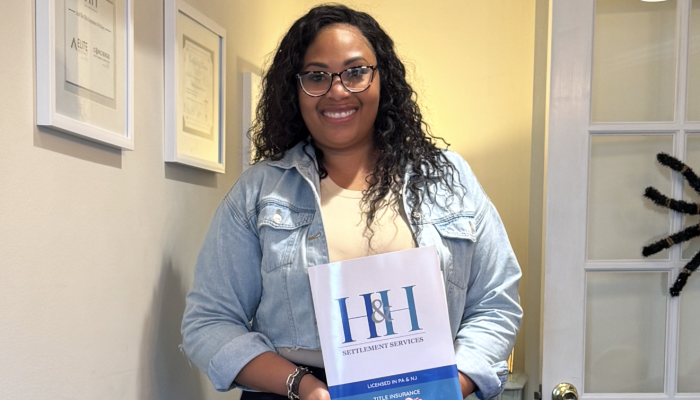 Sameerah Rowland of Ready for the World Academy holding the title of her property