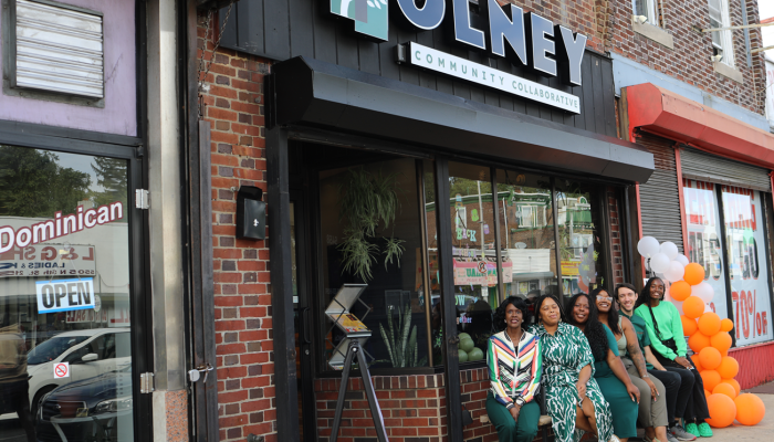 People from Olney Community Collaborative sitting in front of the 5458 N. 5th St. site acquired through the Neighborhood Economic Development Grant Program