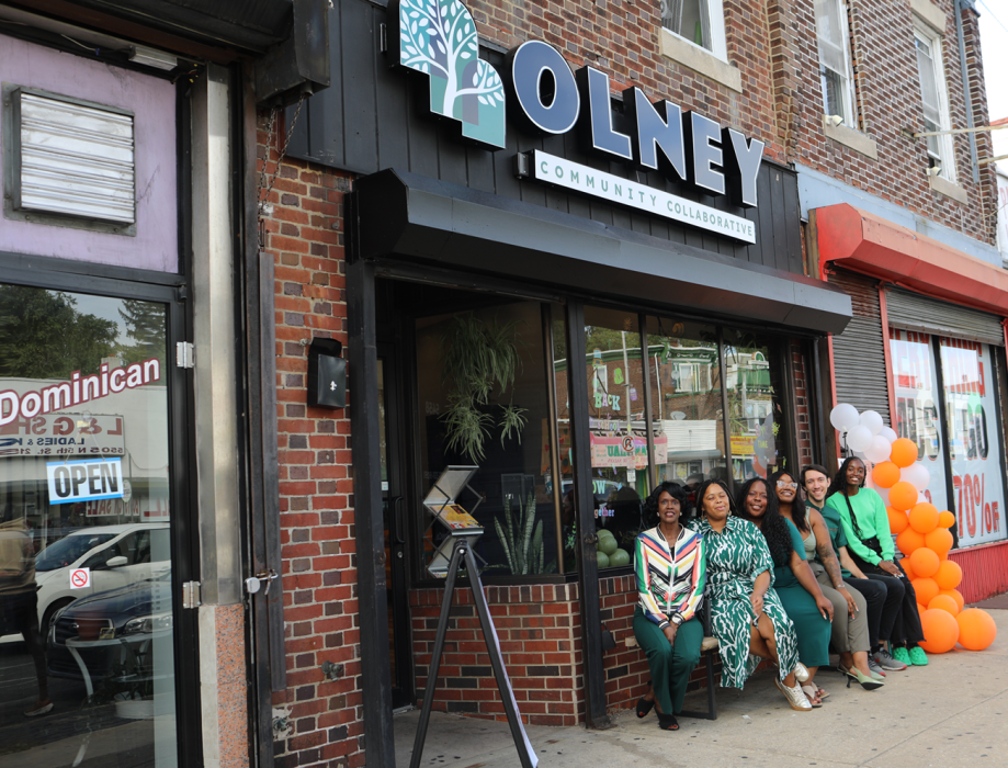 People from Olney Community Collaborative sitting in front of the 5458 N. 5th St. site acquired through the Neighborhood Economic Development Grant Program