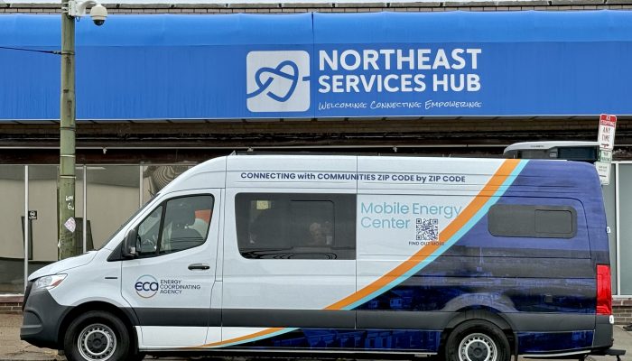 An electric van labeled as the "Mobile Energy Center" parked in front of a building in Philadelphia.