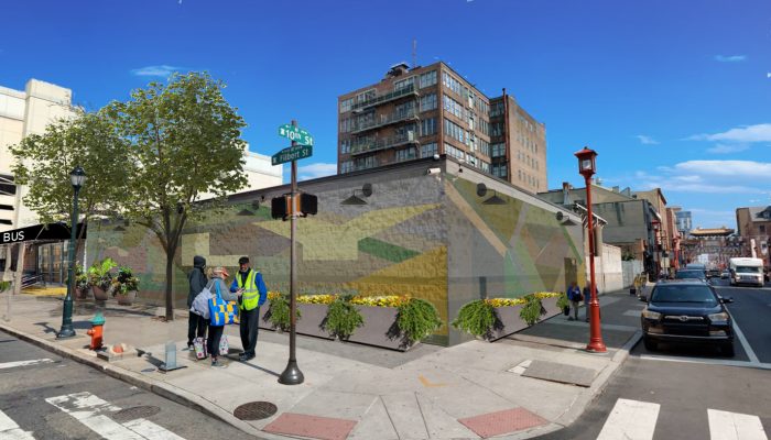 A digitally altered image to show what the Philadelphia intercity bus station will look like after it is renovated. The one-story building is wrapped in a mural with planters and security cameras positioned outside.