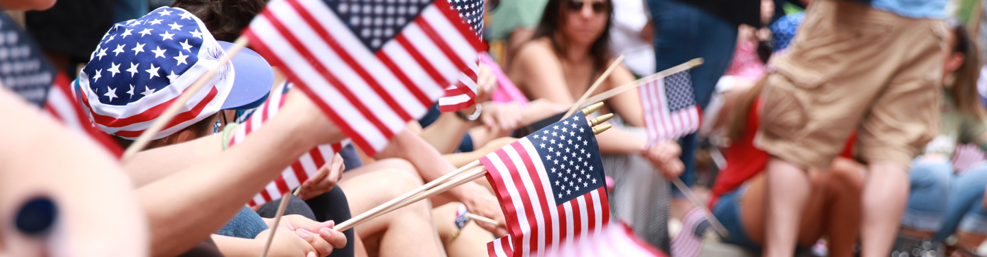 People waving American flags at the Independence Day Parade in Philadelphia July 2016