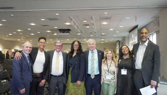City leaders and conference attendees post for a group shot