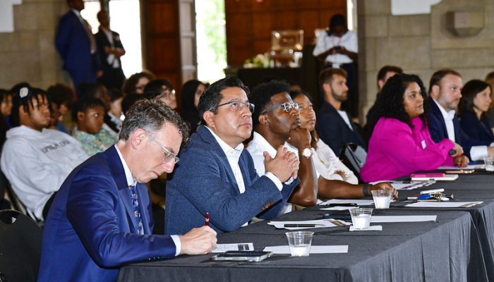 panel of people sitting at a table