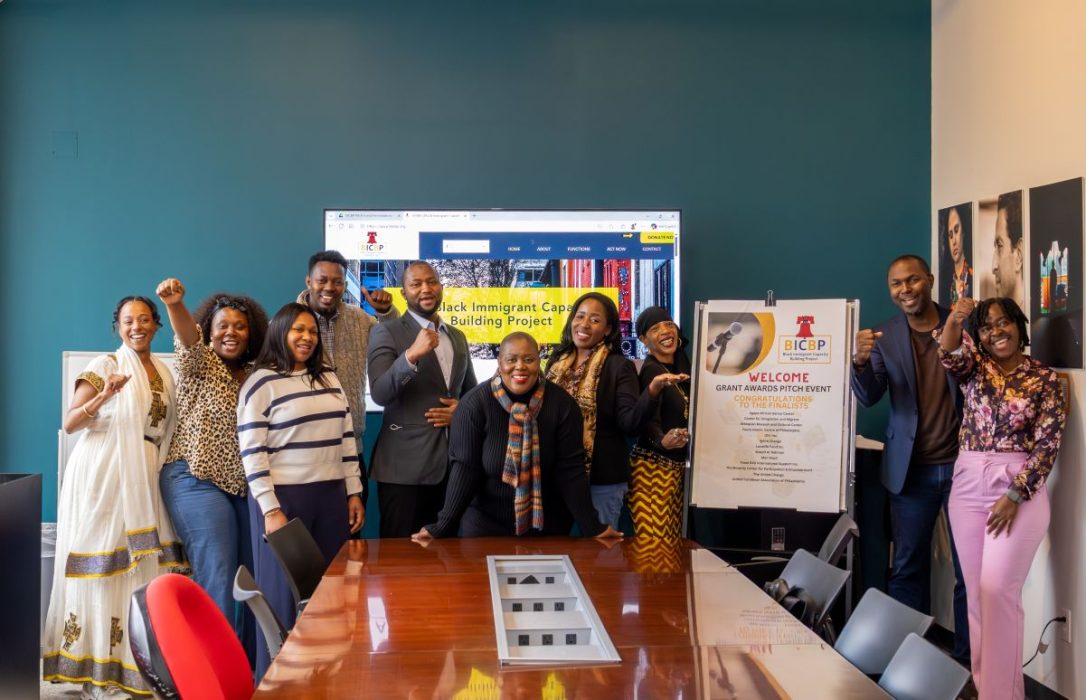 Group photo of community members in a board room.