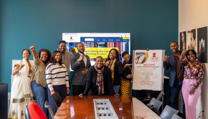 Group photo of community members in a board room.