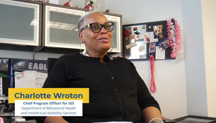 Photo of Charlotte Wroton, Chief Program Officer for IDS, sitting at her desk