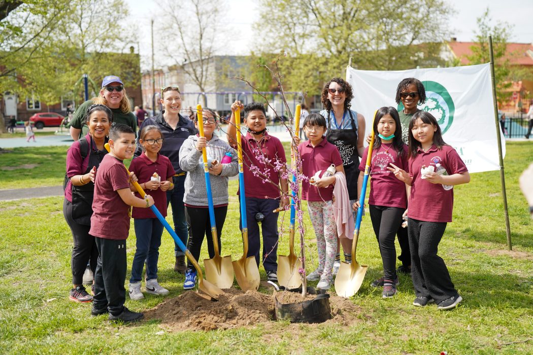 Philadelphia Parks & Recreation staff and Mifflin Square students gather around newly planted trees during Arbor Day.