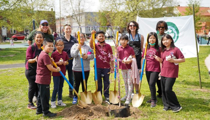 Philadelphia Parks & Recreation staff and Mifflin Square students gather around newly planted trees during Arbor Day.