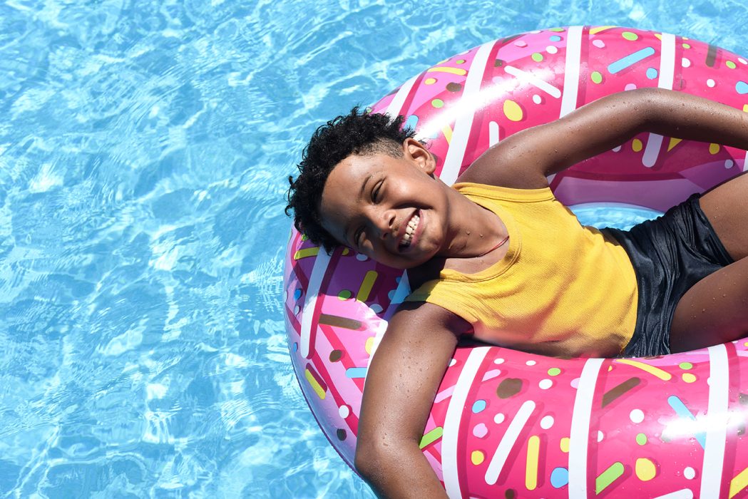 Happy boy lying on an inflatable