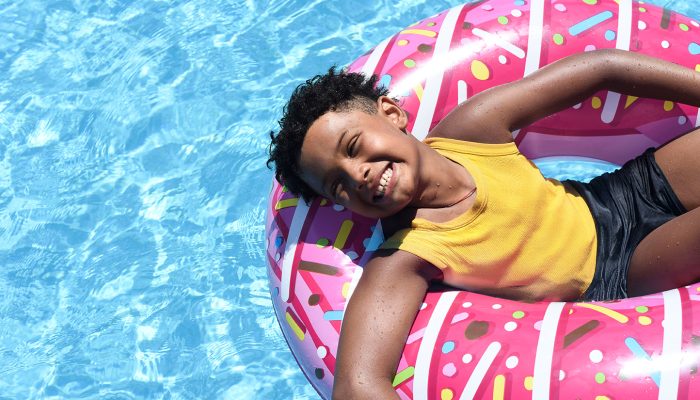 Happy boy lying on an inflatable