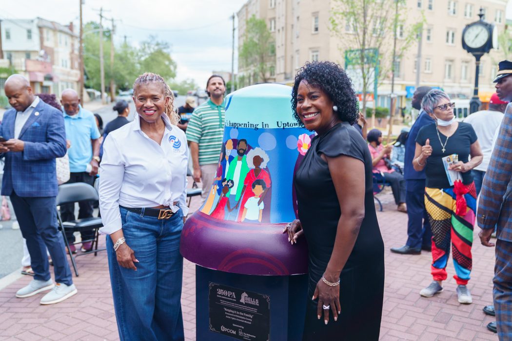 Mayor Parker stands in front of a commemorative liberty bell that was gifted to a local community organization in celebration of America's 250th.