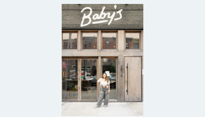 Baby's Kusina business owner standing in front of the business