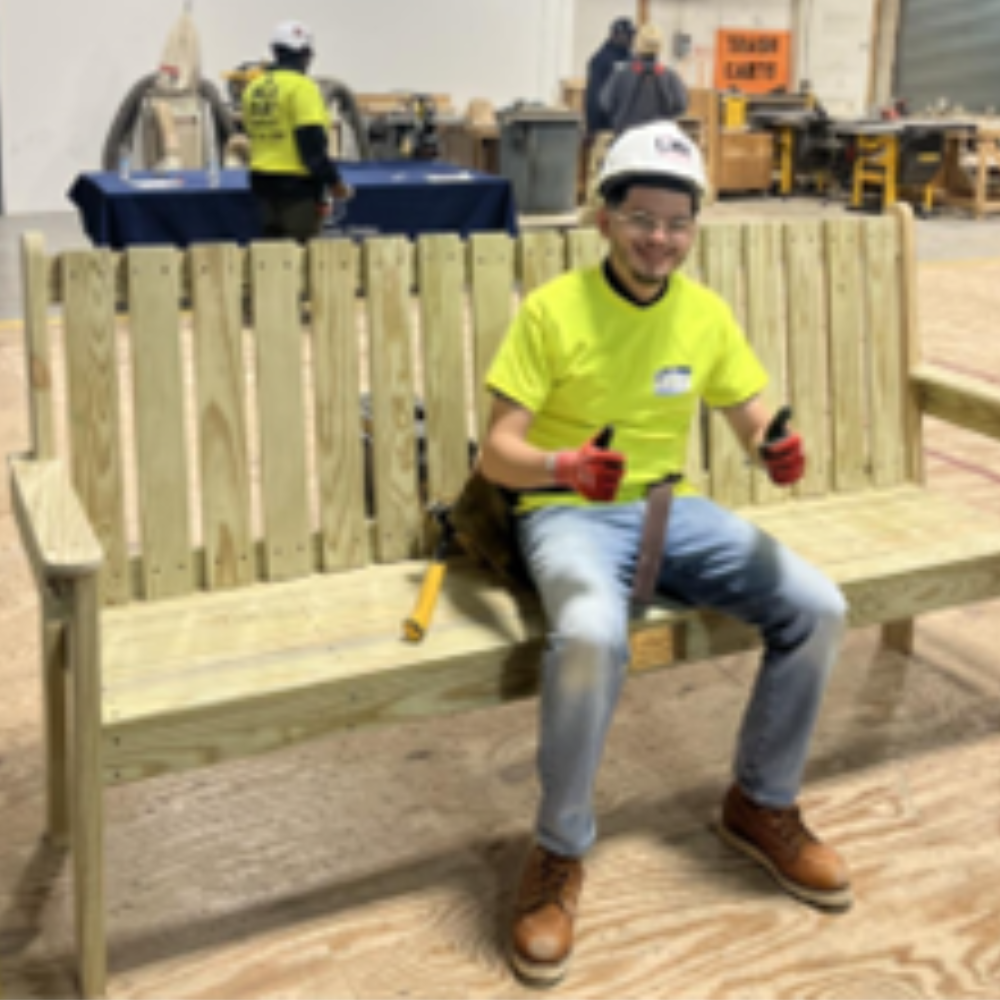 construction worker sitting on bench with thumbs up