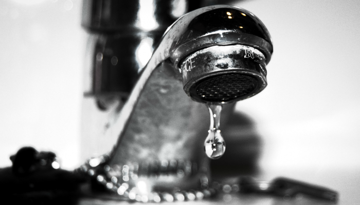 Water droplets from a kitchen faucet