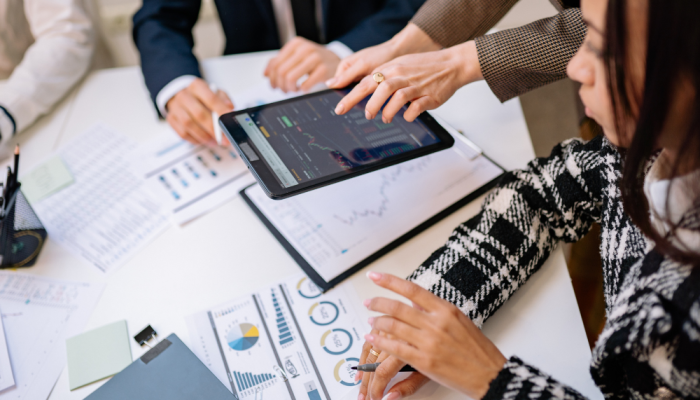 Group of employees reviewing data reports