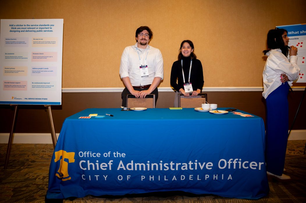 Two members of the CAO team staffing the Service Standards table.