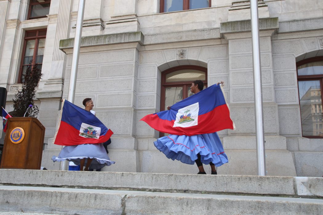 Two dancers in traditional Haitian dresses.