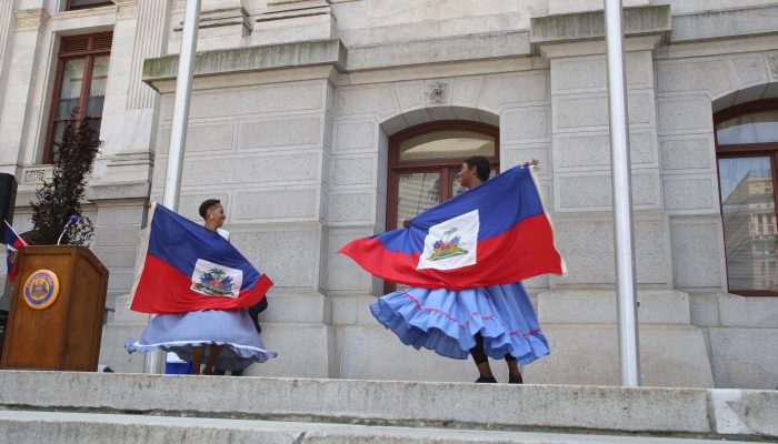 Two dancers in traditional Haitian dresses.